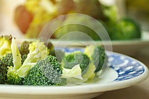 Fresh juicy broccoli is on the plate, small depth of field