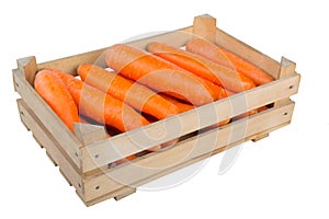 Fresh juicy carrot in a wooden box