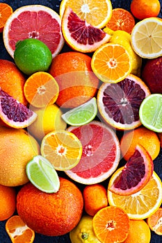 Fresh juicy citrus fruits - oranges, mandarins, lemons and limes, top view