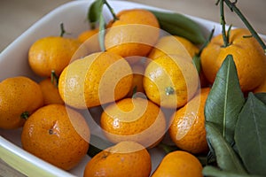 Fresh juicy clementine mandarins on wooden board