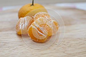 Fresh juicy clementine mandarins on wooden board