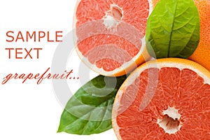 Fresh juicy grapefruits with green leafs