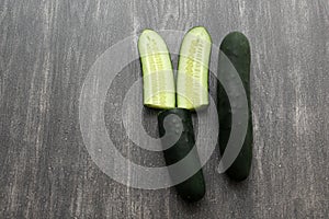 Fresh and juicy green cucumbers ready to cut in the kitchen and eat in salad