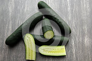 Fresh and juicy green cucumbers ready to cut in the kitchen and eat in salad