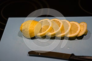 Fresh juicy lemon. Slice thin slices on a cutting board