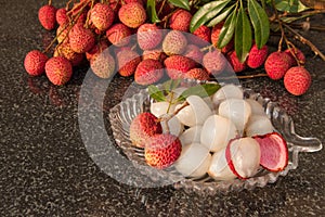 Fresh juicy lychee fruit on a glass plate. Organic leechee sweet fruit.