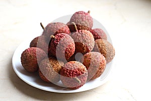 Fresh and juicy lychees on neutral background.