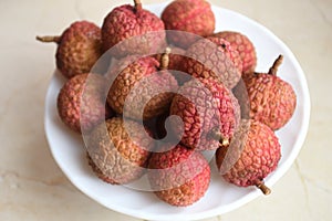 Fresh and juicy lychees on neutral background.