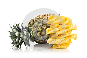 Fresh juicy nutritious cut pineapple with whole fruit as backgro