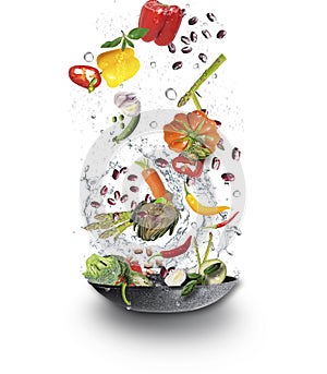 Fresh Juicy organic vegetables falling  into cooking pot with water splash. Veggy concept photo