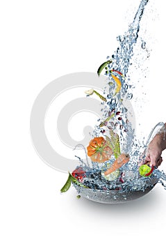 Fresh Juicy organic vegetables falling  into  pan with water splash isolated on white background