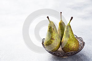 Fresh juicy Pears Conference in a basket on a grey background. Selective focus. Copy space