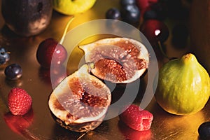 Fresh juicy ripe figs cut in half lie on plate. Exotic tropical fruits, berries.