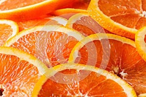 Fresh juicy orange fruit rings close up background.