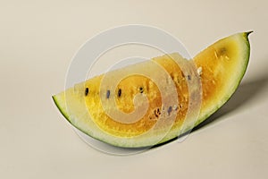 Fresh juicy slice of yellow watermelon on a beige background. Organic vegetables and fruits