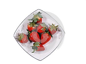 Fresh and juicy strawberries on a white plate. Top view