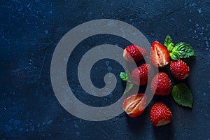 Fresh juicy  strawberry on a dark background. Summer red berries on black