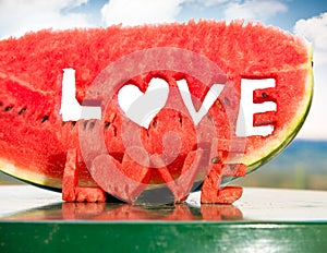 Fresh juicy watermelon slice with love letters word