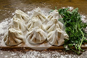 Fresh khinkali made from dough with meat inside, a national Georgian dish. Fresh dough, flour and herbs.