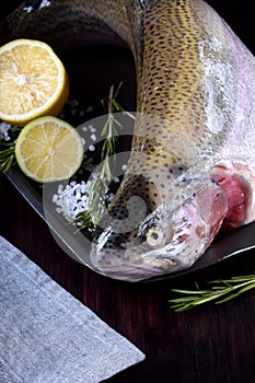 Fresh lacustrine trout on black tray