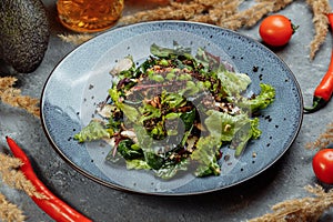 Fresh lamb lettuce salad with avocado, cucumber, salmon, cherry tomatoes.