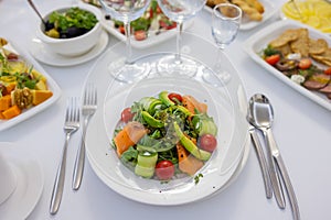 Fresh lamb lettuce salad with avocado, cucumber, salmon, cherry tomatoes. Dressing with honey, dijon mustard, olive oil