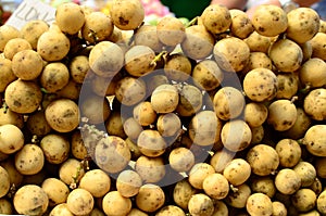 Fresh lanzones fruit symmetrically to attract buyers at market stall photo