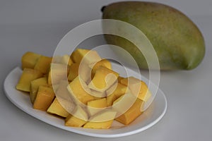 Fresh large totapuri mangoes sliced to small pieces, juicy and vibrant in color photo