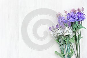 Fresh lavender flowers of spring time and sunny day on white wood table background.