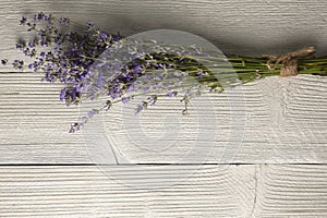 Fresh lavender flowers on white wood table background. Copy space for your text