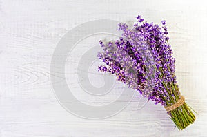 Fresh lavender flowers on white wood table background free space