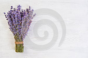 Fresh lavender flowers on white wood table background free space