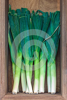 Fresh leek in a wooden box