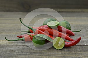 Fresh lemon cut half with chili on wooden background