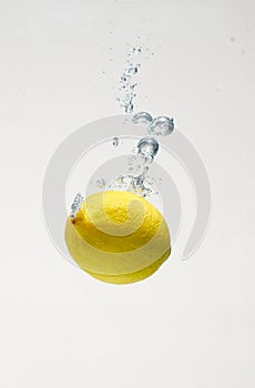 Fresh lemon drop on water with babble