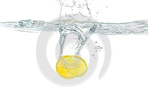 Fresh lemon dropped into water splashing