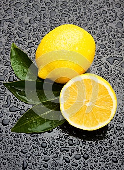 Fresh lemon fruit on wet surface