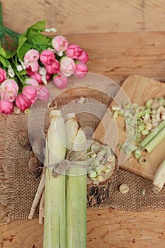 Fresh lemon grass is herb on wood background.