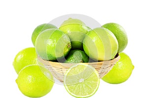 Fresh lemon lime citrus fruit in bamboo basket in white background