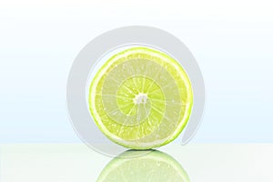 Fresh lemon lime citrus fruit slice in sky blue background