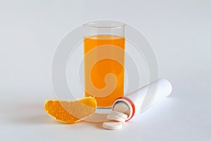 Fresh lemon and oranges, vitamin C pills in container isolated on white background.