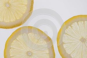 Fresh lemon slices against a white background