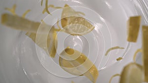 Fresh lemon slices and lemon peels rain on yogurt â€“ Close up