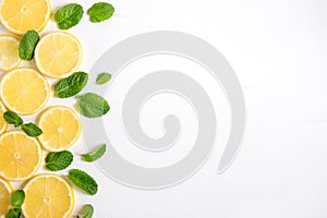 Fresh lemon slices on a white background. Background with lemon and mint. Beautiful photo with citrus. Vitamin C. Lemon and Fresh