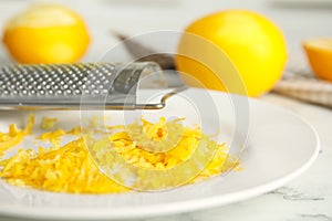 Fresh lemon zest on plate, closeup view