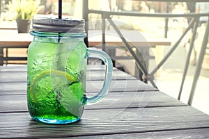 Fresh lemonade on wooden background in summer cafe photo