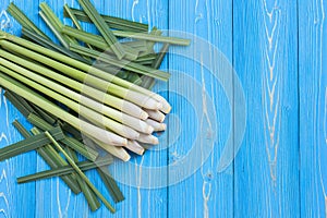Fresh lemongrass or citronella grass leaf on blue wooden plank photo