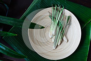 Fresh Lemongrass Cymbopogon citratus or citronella, serai on a wooden plate