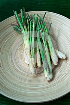 Fresh Lemongrass Cymbopogon citratus or citronella, serai on a wooden plate