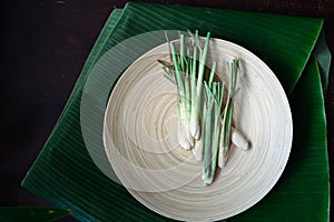 Fresh Lemongrass Cymbopogon citratus or citronella, serai on a wooden plate